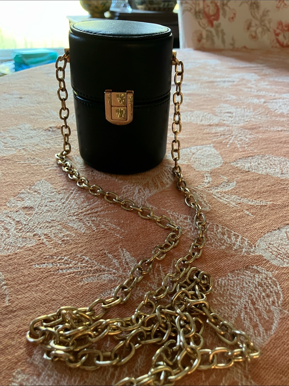 Black Leather Cylinder Crossbody Bag with Gold Chain